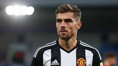 A 30-year-old male Newcastle United coach, waist-up, in a black and white kit, with a determined expression