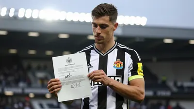 Mid-30s anonymous Newcastle United midfielder, lean build, waist-up, wearing the black-and-white home shirt with the...
