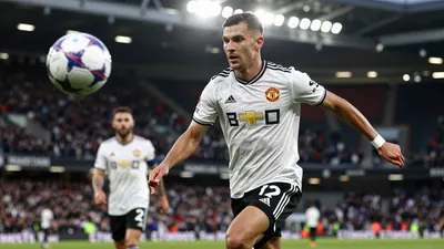A tight action crop of an anonymous Newcastle United player in a white jersey with black shorts, running with the ball...
