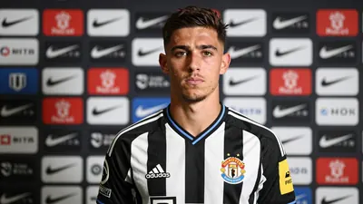 A determined 21-year-old Newcastle United midfielder, athletic build, stands in front of a Magpies' press backdrop...