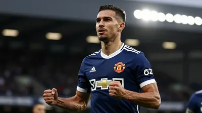 A focused shot of a muscular midfielder in a Newcastle United kit, deep blue with white trim, celebrating a goal with...