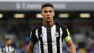 A young, determined Newcastle United winger, mid-20s, in black and white home kit with the club crest sharply rendered on...