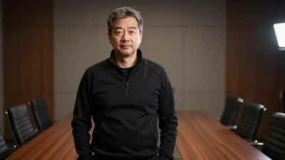 A 45-year-old manager in a black tracksuit, waist-up, standing in a dimly lit boardroom